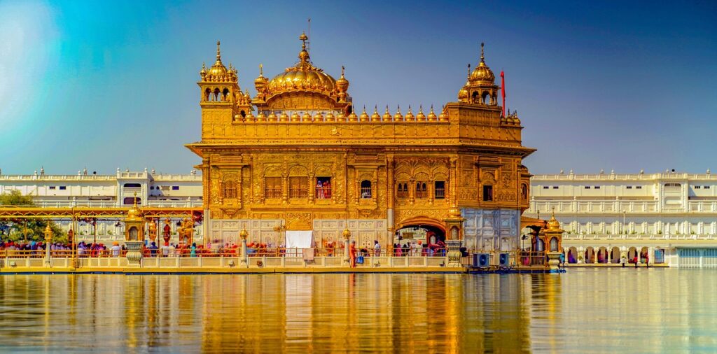 Golden Temple Amritsar reflecting in Sarovar at sunrise
