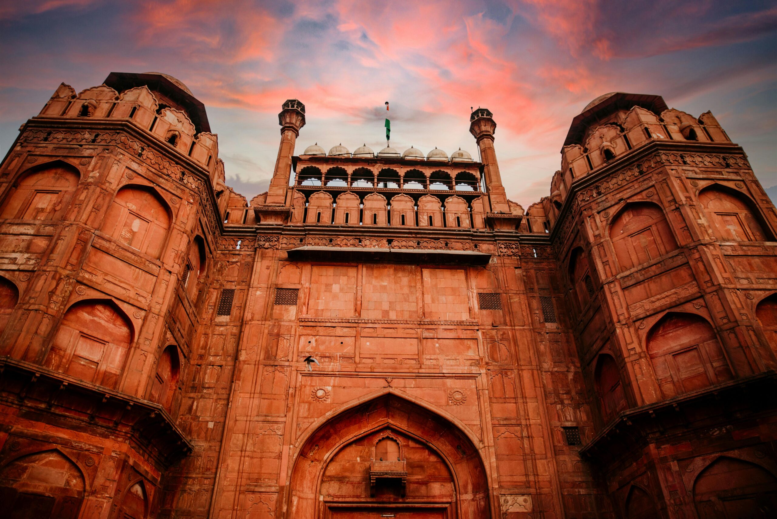 Stunning low angle shot of The Red Fort in New Delhi with a dramatic sky.