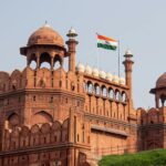 Front view of the historic Red Fort in New Delhi with the Indian flag waving.