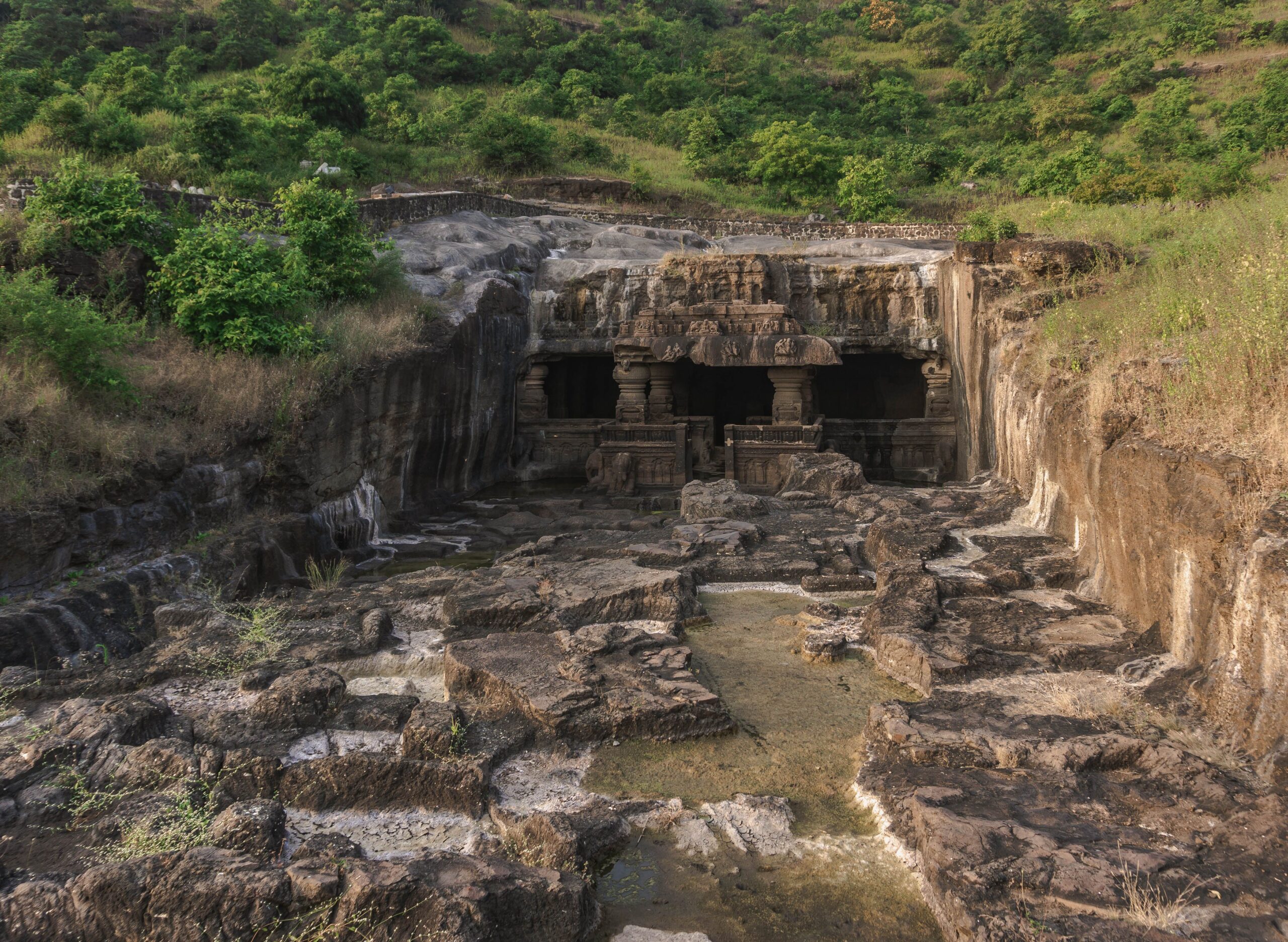 Explore the majestic Ellora Caves carved into the rocky hillside in Maharashtra, India.