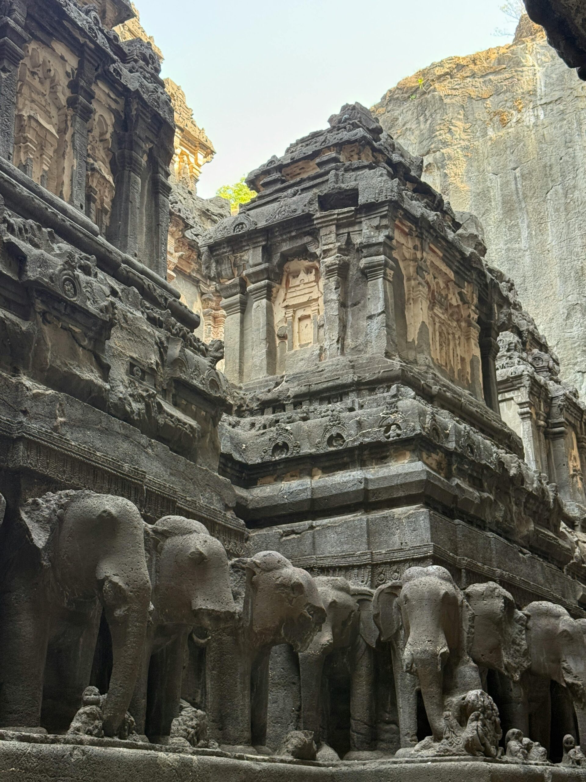 Life-sized carved elephant sculptures on courtyard walls of Kailasa Temple Ellora